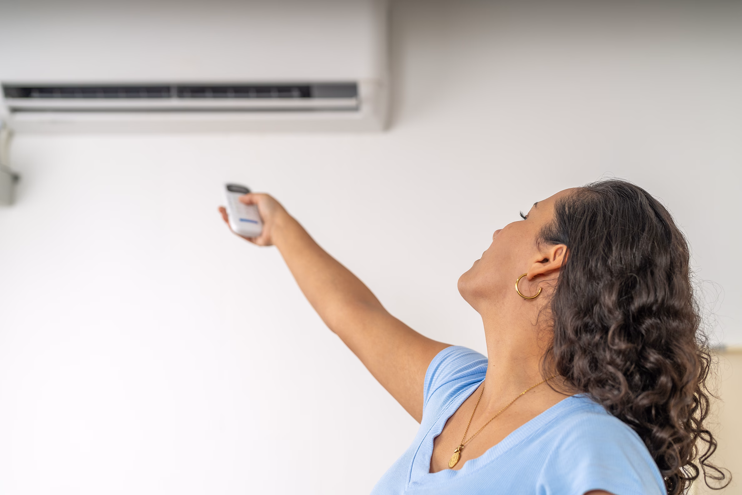 woman-turning-on-air-conditioning